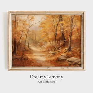 May include: A framed painting of a forest path in autumn. The trees are mostly bare, but some have leaves in shades of yellow, orange, and red. The path is lined with rocks and the ground is covered in fallen leaves.