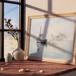 May include: A framed watercolour painting of a sailboat on a calm body of water. The painting is in a gold frame and is hanging on a wall. There are two white ceramic vases and a seashell on a wooden table in front of the painting.