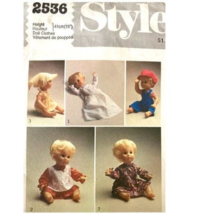 May include: A vintage sewing pattern for doll clothes. The pattern includes four different outfits for a 16-inch doll. The outfits include a sun hat and dress, a nightgown, overalls and a shirt, and two dresses.