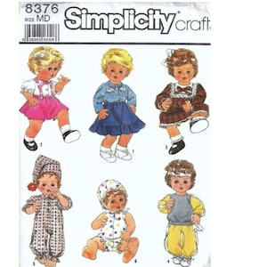 May include: Simplicity Craft doll sewing pattern number 8376, size MD. The pattern includes instructions for making six different dolls, including a doll wearing a pink skirt and a blue and white striped shirt, a doll wearing a blue skirt and a blue and white plaid shirt, a doll wearing a brown dress with a white collar, a doll wearing a blue and white checkered jumpsuit, a doll wearing a yellow and white striped dress, and a doll wearing a grey sweatshirt and yellow trousers.