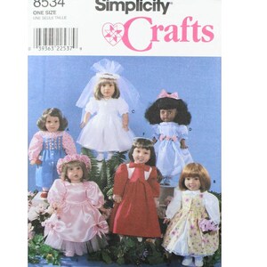 May include: Simplicity Crafts pattern 8534 for making doll clothes. The pattern includes instructions for making five different outfits: a white dress with a veil, a blue dress with a pink sash, a red dress with a white collar, a pink dress with a white lace overlay, and a floral print dress with a white overlay.