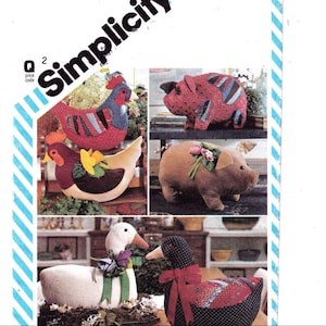 May include: A sewing pattern for making stuffed animal toys. The pattern includes instructions for making a chicken, a pig, and a goose. The pattern is from Simplicity.