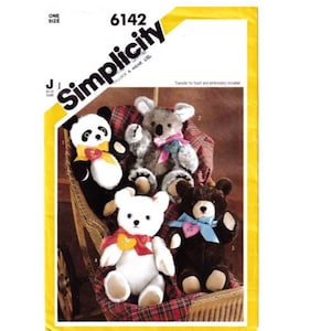 May include: Simplicity sewing pattern number 6142 for making four stuffed animals: a panda, a koala, a white bear, and a brown bear. The pattern includes a transfer for the heart and embroidery.