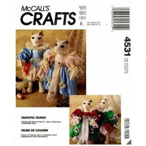 May include: A sewing pattern for making two whimsical cat dolls. The pattern is called "Fanciful Felines" and "Felins de Charme". The pattern is from McCall's Crafts and the pattern number is 4531.
