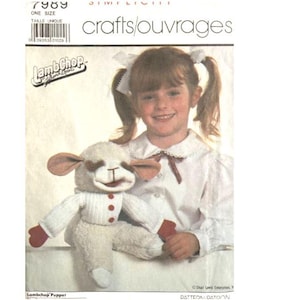 May include: A sewing pattern for a Lamb Chop puppet. The pattern is from the crafts/ouvrages line and is number 7989. The pattern is for one size and includes instructions for making a white lamb puppet with red mittens.