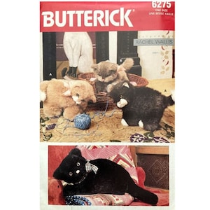 May include: A vintage sewing pattern for making plush cat toys. The pattern is from Butterick and is for one size. The pattern includes instructions for making three different cats: a black cat, a gray cat, and a brown cat. The pattern also includes a picture of a white cat.