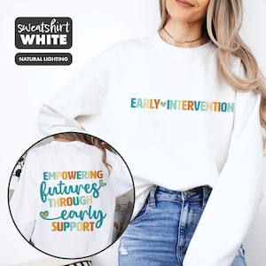 May include: White sweatshirt with the text "EARLY INTERVENTION" on the front and "EMPOWERING futures THROUGH early SUPPORT" on the back. The text is in colorful letters with a heart symbol.