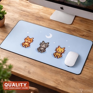 May include: A light blue rectangular mousepad featuring three pixelated cat illustrations in orange, gray, and yellow. The design includes a crescent moon and stars. A white mouse rests on the pad.