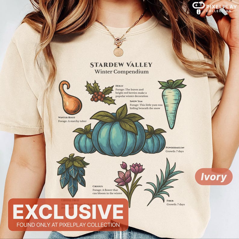 May include: Ivory-colored t-shirt featuring a graphic from Stardew Valley's Winter Compendium. The design includes illustrations of winter crops like Winter Root, Holly, and Snow Yam. The text "EXCLUSIVE" is displayed at the bottom.