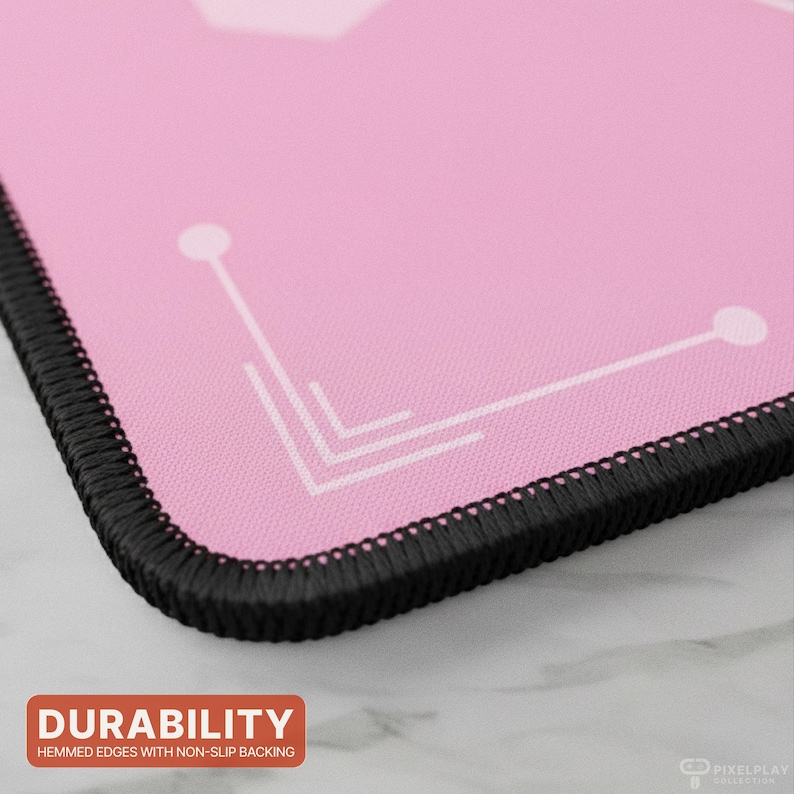 May include: Pink mousepad with a white geometric design and black stitched edges. The mousepad has the word "DURABILITY" in a red box, with the text "HEMMED EDGES WITH NON-SLIP BACKING" below it.