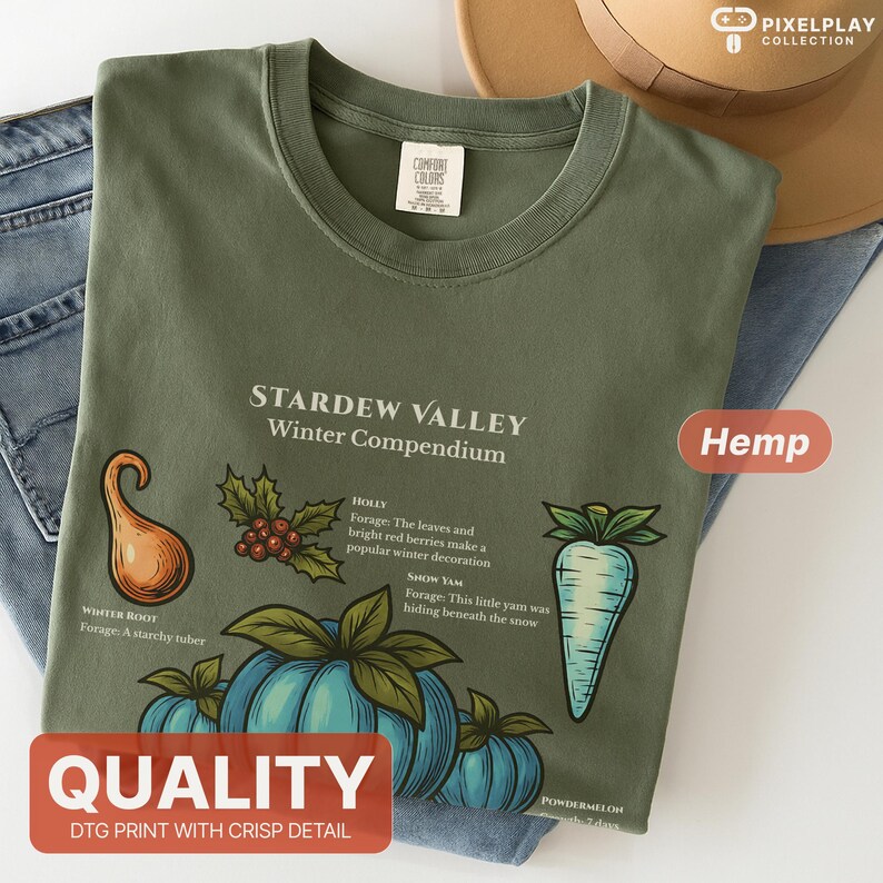 May include: Olive green t-shirt featuring a botanical illustration from Stardew Valley's Winter Compendium. The design includes drawings of winter root, holly, show yam, and powder melon. The shirt has the word "Hemp" and "Quality" printed on it.