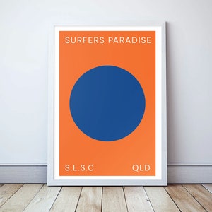 May include: A minimalist poster with the text "SURFERS PARADISE" in white on an orange background. A large blue circle is centred on the poster. The text "S.L.S.C" and "QLD" are at the bottom of the poster.