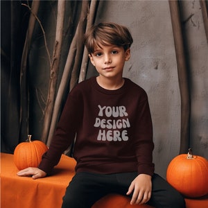 Kid Boy Maroon Sweatshirt Mockup | Maroon Gildan 18000B Mockups | G180B Kid Maroon sweater mock | halloween setting | background pumpkins