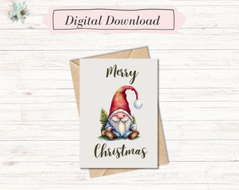 May include: A printable Christmas card featuring a cartoon gnome wearing a red hat and blue pants. The gnome is sitting next to a small green tree and holding a snowball. The card says "Merry Christmas" in a brown script font.