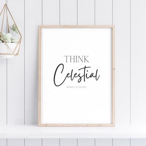 May include: A framed print with the text "Think Celestial" in black script font, with the name "Russell M. Nelson" in smaller font below. The print is on a white background and is framed in a light wood frame.