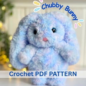 May include: A plush toy shaped like a bunny with soft, variegated blue and purple fur, dark eyes, and a pink nose. The text "Chubby Bunny" appears at the top, and the text "Crochet PDF PATTERN" is displayed at the bottom of the image.