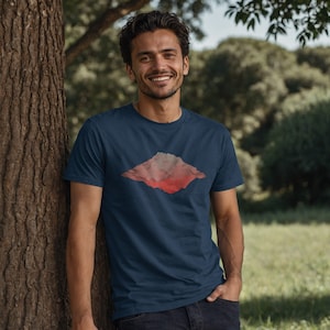 May include: A navy blue t-shirt with a red and pink mountain graphic design.