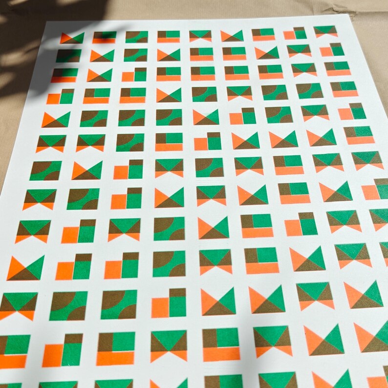 Limited edition geometric riso print on quality paper — small squares with triangles and curves in green, orange and brown