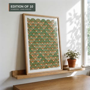 May include: A framed art print featuring a repeating pattern of green and orange semicircles on a white background. The text "EDITION OF 10 NUMBERED - HAND-PRINTED" is visible in the upper left corner of the image.