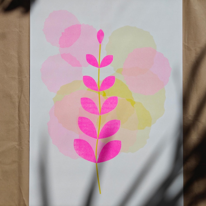 Limited edition A3 botanical art print — a fluorescent pink leaf pattern with yellow circle details, handmade two-layer risograph