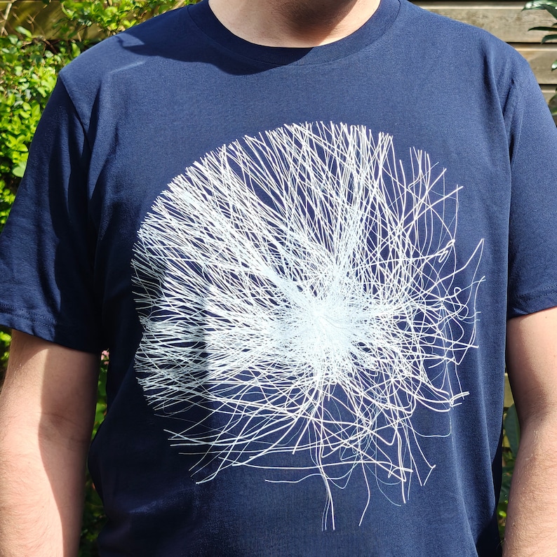 Close-up of the front of the navy t-shirt showing the generative white particle sphere print in detail