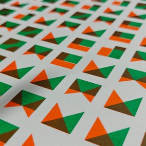 Handmade risograph print with an abstract geometric tile pattern in green and orange for contemporary interiors