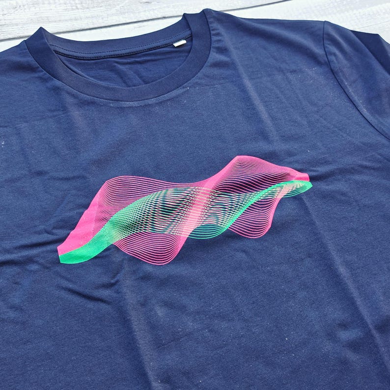 French navy t-shirt flat lay with a pink and green psychedelic wave optical illusion print