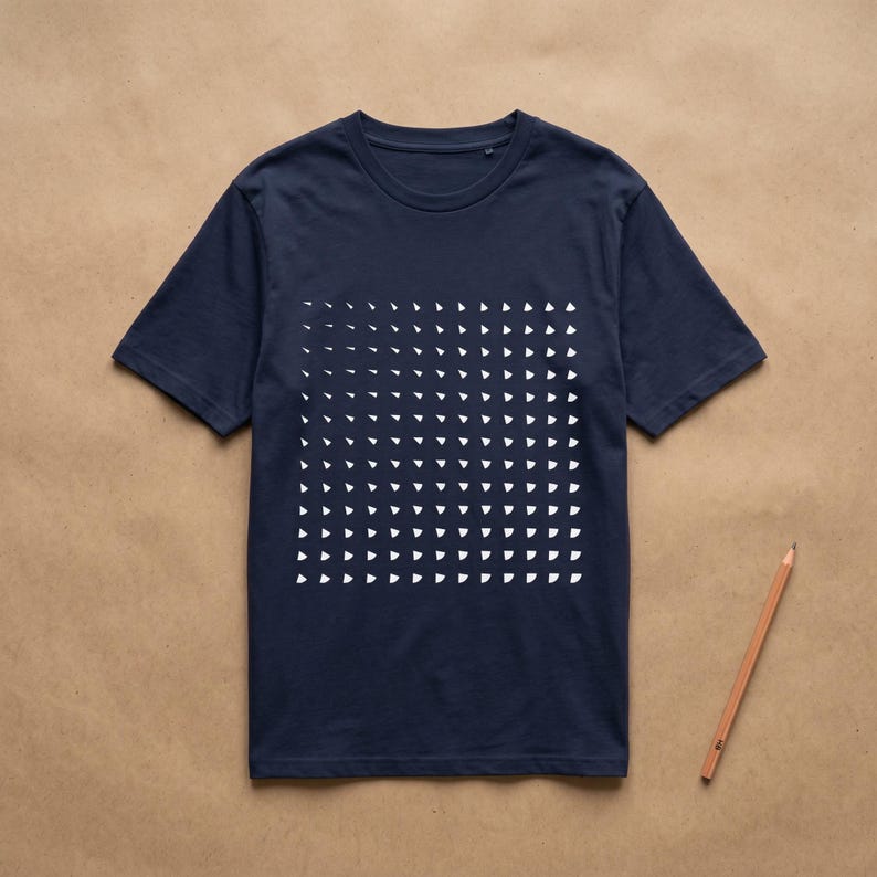 French navy t-shirt with the white rotating triangle grid print, flat lay on kraft paper with a pencil
