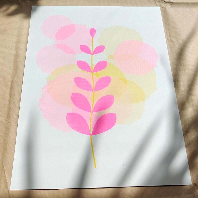 Modern botanical riso illustration in A3 — pink leaves on a yellow stem over layered pastel shapes, limited edition risograph