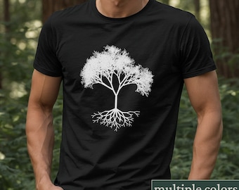 May include: A black t-shirt with a white silhouette of a tree with roots. The tree has a simple design with many branches and a thick trunk. The roots are spread out and detailed.