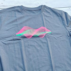 Heather grey t-shirt flat lay with the pink and green generative wave surface print
