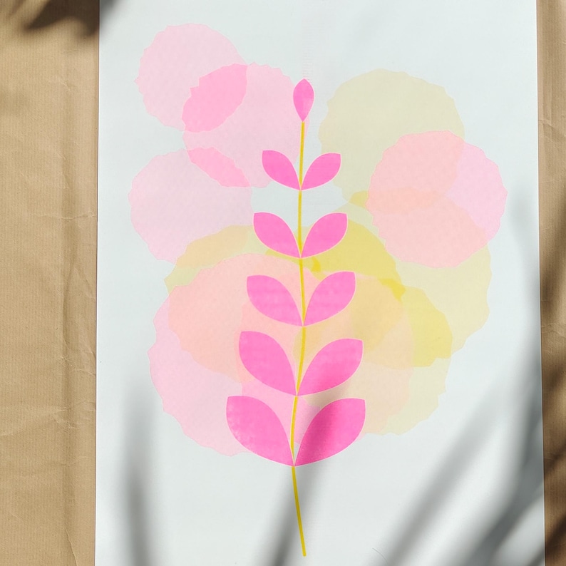Detail of the botanical riso print showing the pink leaves and layered pastel circles of the two-colour design