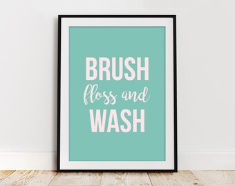 Puede incluir: Una impresión enmarcada de color turquesa con el texto "BRUSH floss and WASH" en letras rosas.
