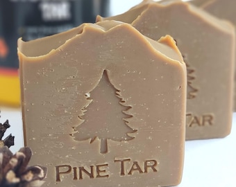 May include: Three bars of brown pine tar soap with a pine tree and "PINE TAR" embossed on the front.