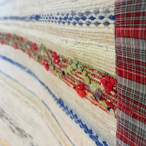 Handmade Woven Rug from Aveiro: Sustainable Elegance with Recycled Fabrics, Checkered Fabric on the edge and colored lines with beige.