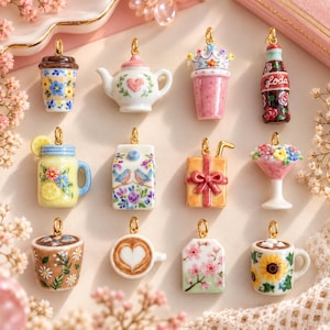 May include: A collection of twelve miniature ceramic charms featuring various designs including a floral coffee cup, a teapot with a heart, a crown-topped drink, a soda bottle, a lemon drink, a milk carton, a gift box, a flower vase, and mugs.