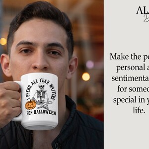 May include: White ceramic coffee mug with a black and white illustration of a skeleton sitting with a pumpkin. The text on the mug reads "I spend all year waiting for Halloween."