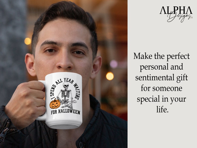 May include: White ceramic coffee mug with a black and white illustration of a skeleton sitting with a pumpkin. The text on the mug reads "I spend all year waiting for Halloween."