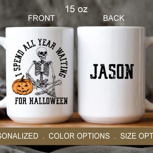 May include: White ceramic mug with a black and white illustration of a skeleton holding a pumpkin. The text on the mug reads "I spend all year waiting for Halloween". The back of the mug has the name "JASON" in black text.