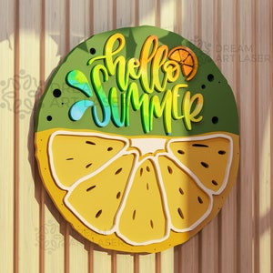 May include: A round wooden sign with a green background and a yellow lemon slice. The sign says "hello summer" in rainbow lettering.