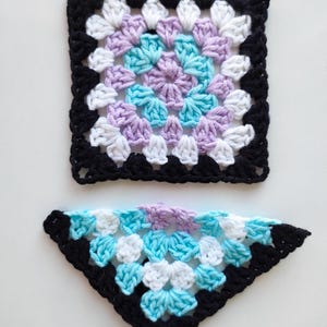 May include: Two crocheted squares, one a square and one a triangle, with a black border and a multi-colored center. The square is purple, white, and blue. The triangle is blue, white, and purple.