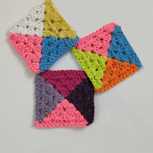 May include: Four crocheted squares in different colors, including pink, purple, blue, green, yellow, and white. Each square is made up of four triangles.