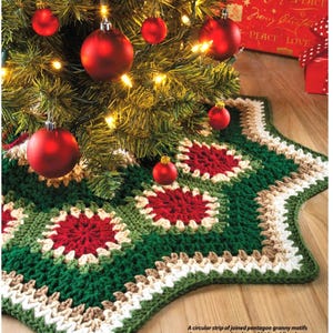 May include: A crocheted Christmas tree skirt in a star shape, featuring green, red, and cream colors. The skirt is made of joined pentagon granny motifs with deep crocheted borders. Red ornaments hang from the tree above.