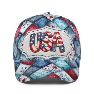 May include: A baseball cap with a patchwork design in red, white, and blue. The word "USA" is prominently displayed on the front in a patriotic font, with stars and stripes. The cap features a curved brim and a classic six-panel construction.