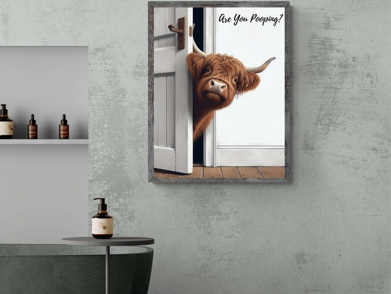 May include: A framed print of a Highland cow peeking around a door with the text "Are You Pooping?" printed on the wall.