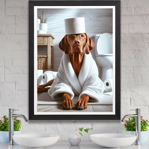 May include: A brown and white dog wearing a white bathrobe and a toilet paper roll on its head. The dog is sitting in a bathroom with a toilet and other toilet paper rolls in the background.