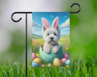 May include: A white Westie dog wearing bunny ears sits inside a cracked Easter egg with pastel colored eggs around it. The dog is in a field of flowers with a blue sky and white clouds in the background.