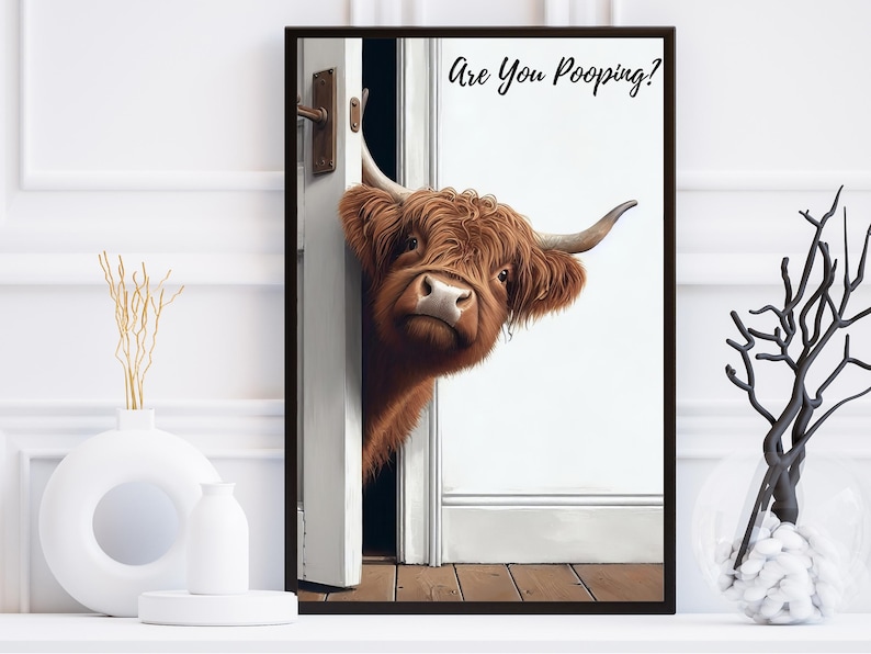 May include: A brown and white Highland cow peeks around a white door frame with the text "Are You Pooping?" printed on the wall behind it.