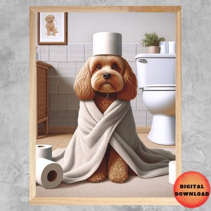 May include: A framed digital art print depicts a brown dog in a bathroom setting. The dog is wrapped in a white towel, with a roll of toilet paper on its head. Additional rolls of toilet paper are on the floor.