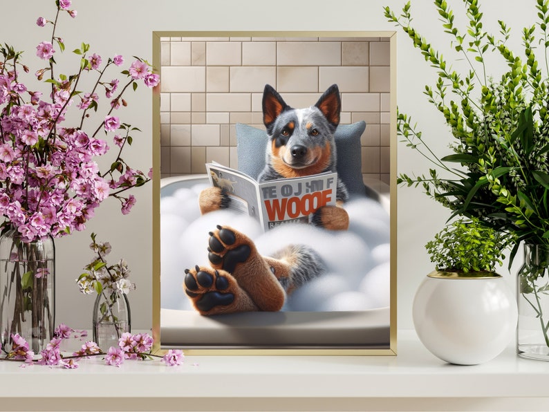 May include: A blue and white Australian Shepherd dog relaxes in a white bathtub filled with bubbles. The dog is wearing a blue collar and is holding a magazine that says "The OJ of Woode".